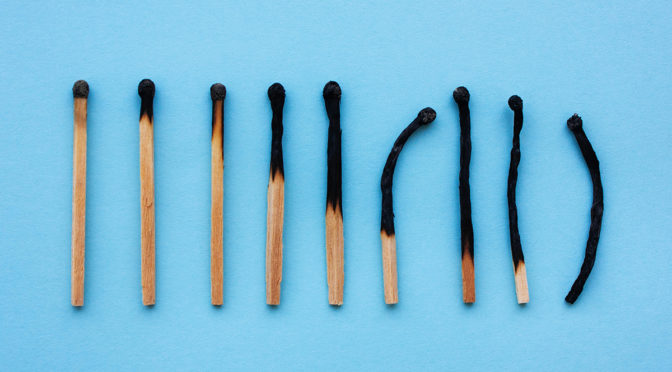 Burned matches in a row on a blue background.