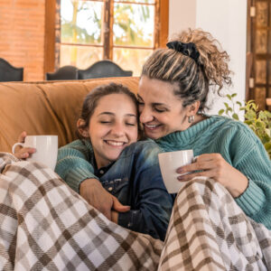 mom and daughter cozy at home and talking to avoid seasonal affective disorder